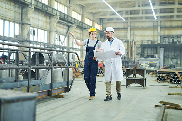 two workers in a manufacturing plant