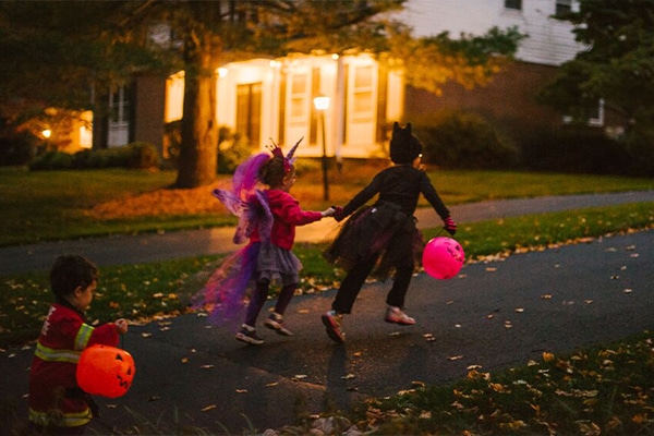 kids trick-or-treating in a neighborhood