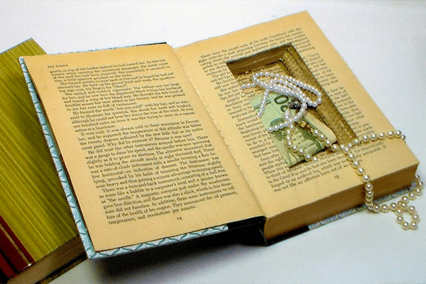 a hollowed book with jewelry